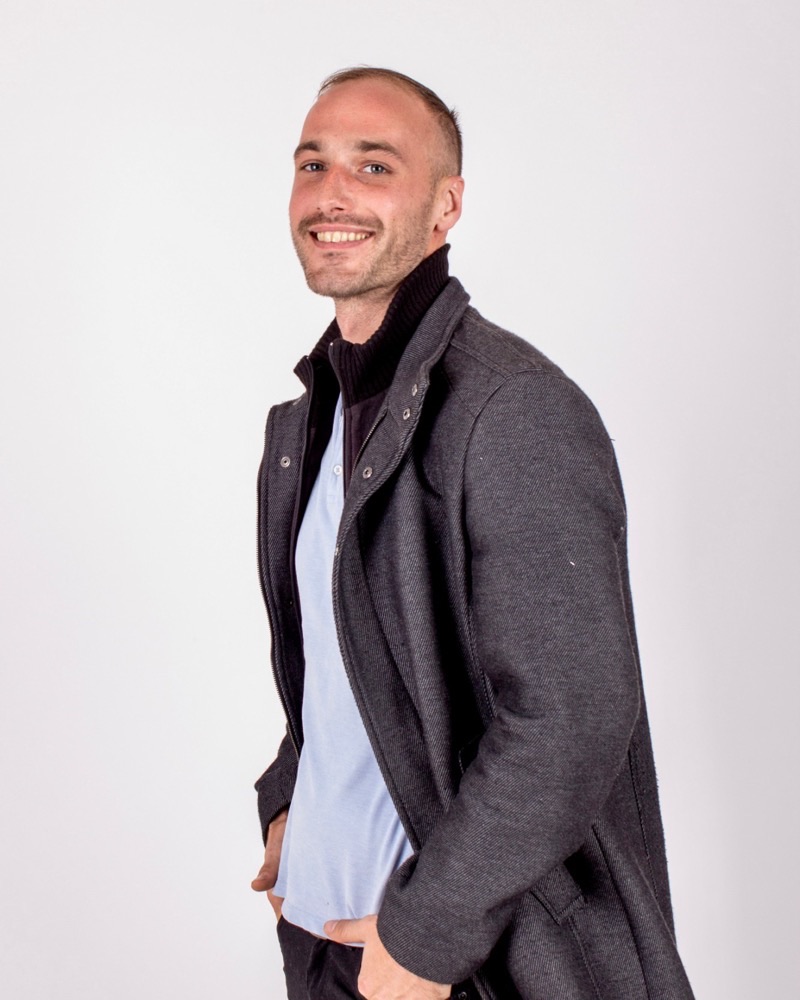 Lautaro Dagorret, smiling, wearing a grey coat